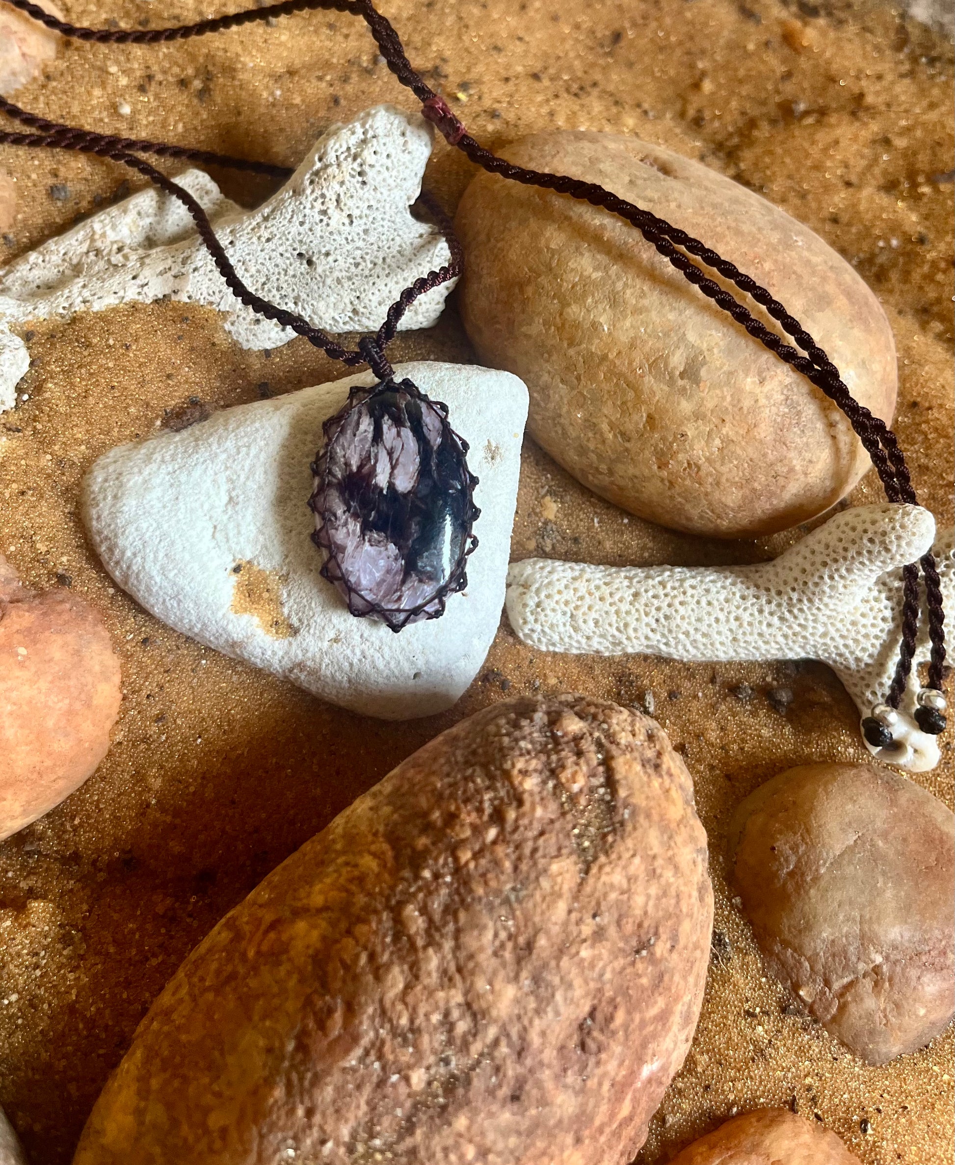 Charoite pendant in macrame cord by Season Stones, featuring a vibrant purple gemstone with intricate knot detailing.