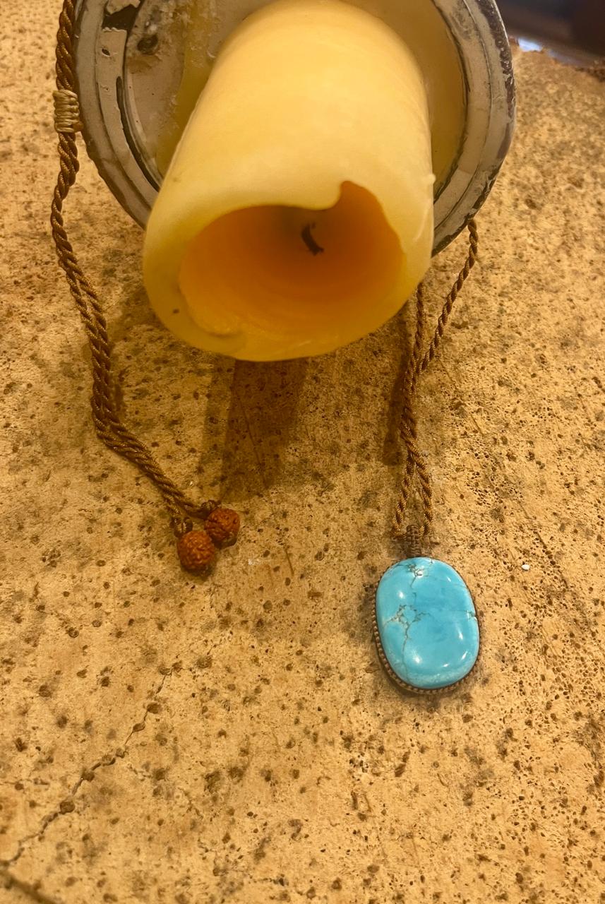 Turquoise pendant with macrame cord from Season Stones, featuring a vibrant blue turquoise stone on a handcrafted knot design.